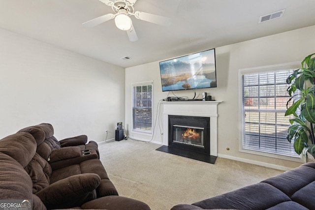 living room with light carpet and ceiling fan