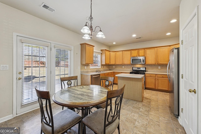 dining area with an inviting chandelier