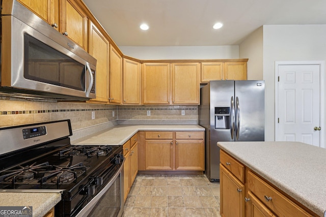 kitchen featuring tasteful backsplash and appliances with stainless steel finishes