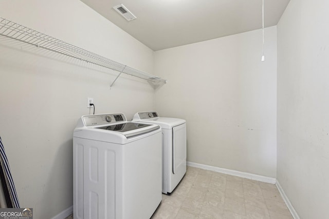 laundry room with washing machine and clothes dryer