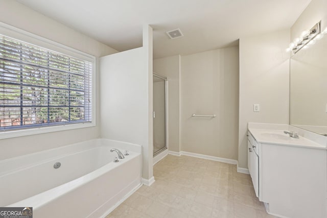 bathroom featuring vanity and shower with separate bathtub