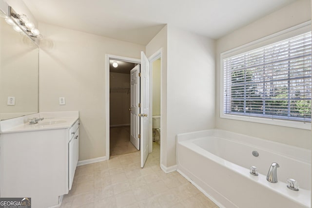 bathroom featuring vanity, toilet, and a bathtub