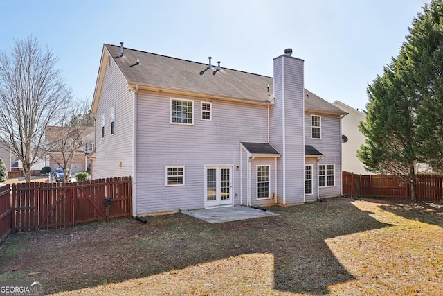 rear view of property with a lawn, a patio, and french doors