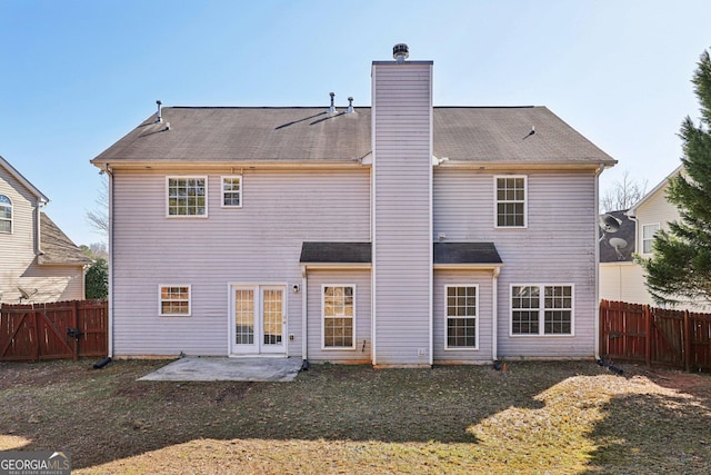 back of house featuring a yard and a patio