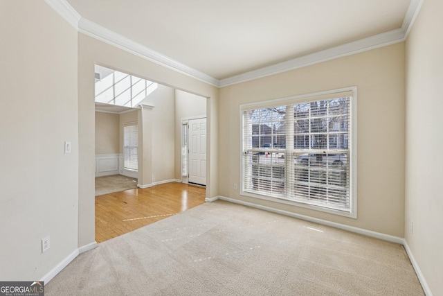 empty room with light colored carpet and ornamental molding