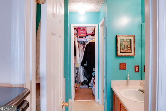 bathroom with vanity and a textured ceiling