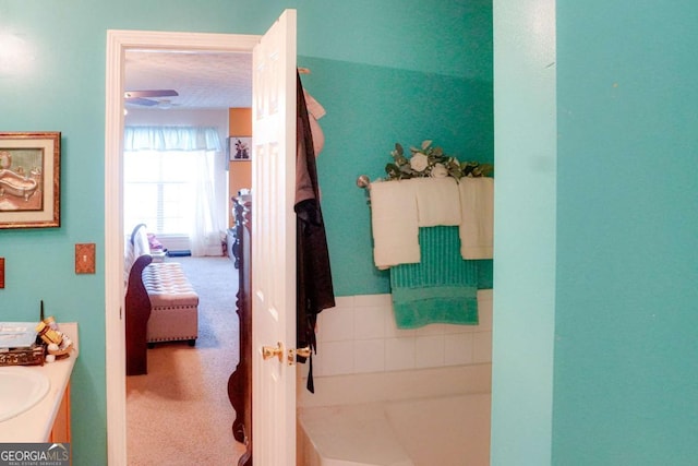 bathroom featuring vanity and a bath