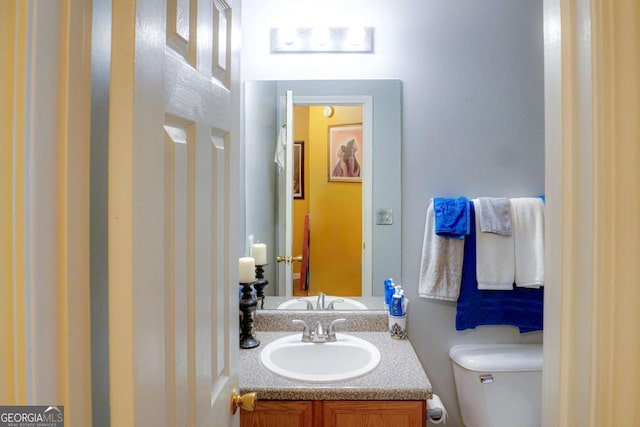 bathroom with vanity and toilet