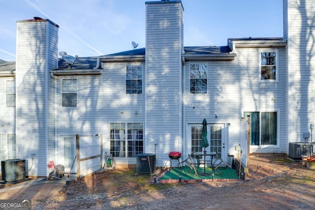 back of house with central air condition unit