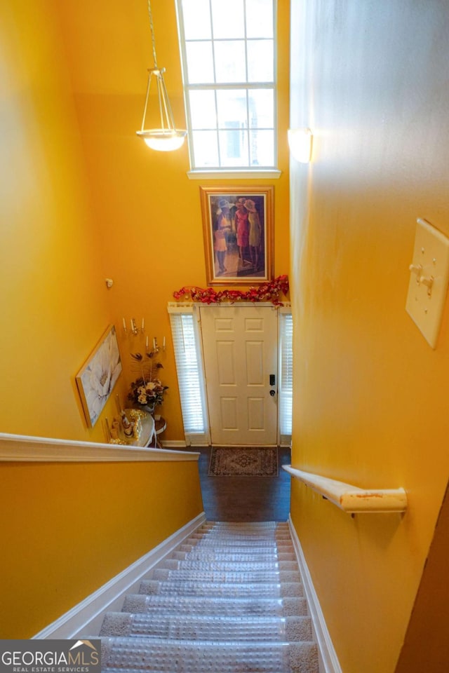 staircase with a towering ceiling