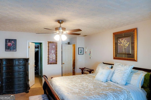 bedroom with light carpet, ceiling fan, and a textured ceiling