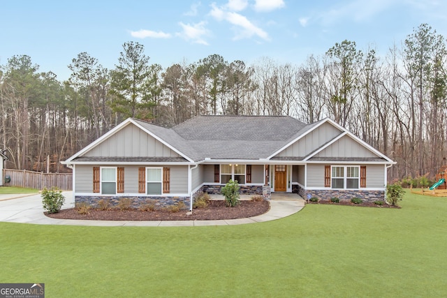 craftsman-style home with a front lawn, a playground, and a porch