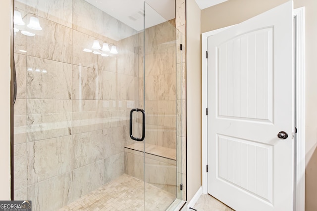 bathroom featuring a shower with door