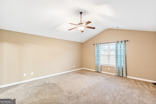 carpeted spare room featuring ceiling fan and lofted ceiling