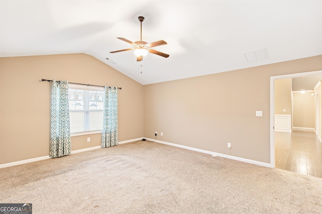 carpeted spare room with lofted ceiling and ceiling fan