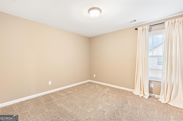 unfurnished room featuring carpet