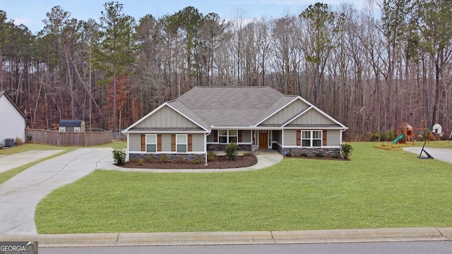 craftsman house with cooling unit, a playground, and a front lawn