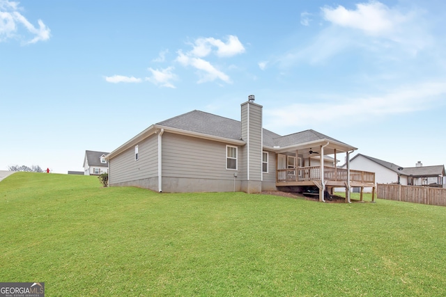 back of house with a wooden deck, a yard, and ceiling fan