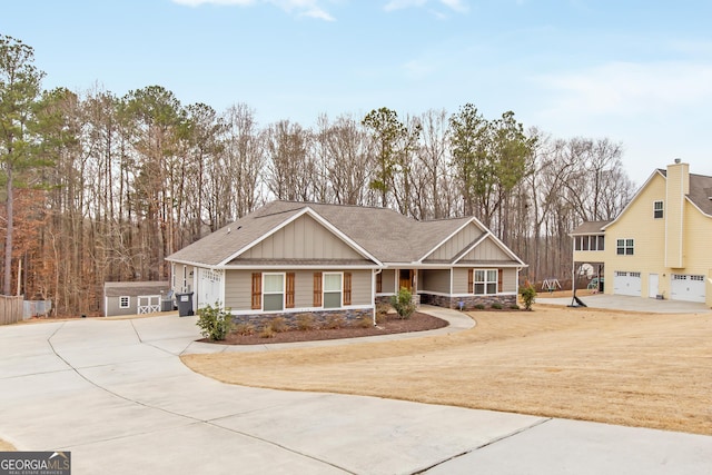 craftsman inspired home with a garage and a front lawn