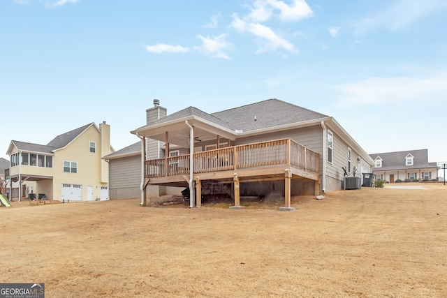 rear view of house featuring a yard, ceiling fan, and a deck