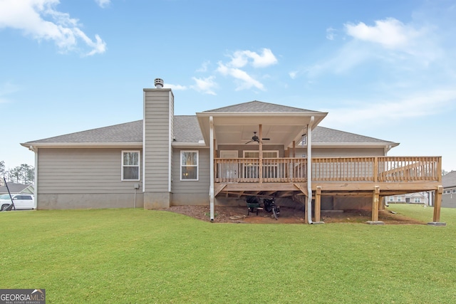 back of property featuring a wooden deck, a yard, and ceiling fan