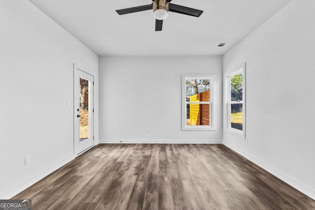 unfurnished room with dark hardwood / wood-style flooring and ceiling fan