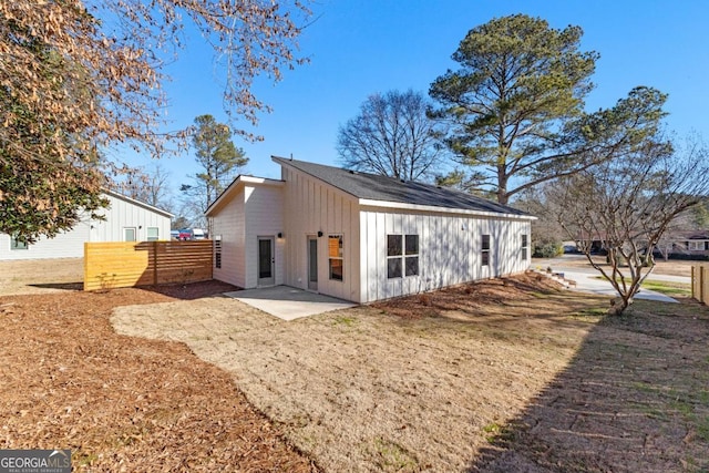 back of property featuring a yard and a patio area