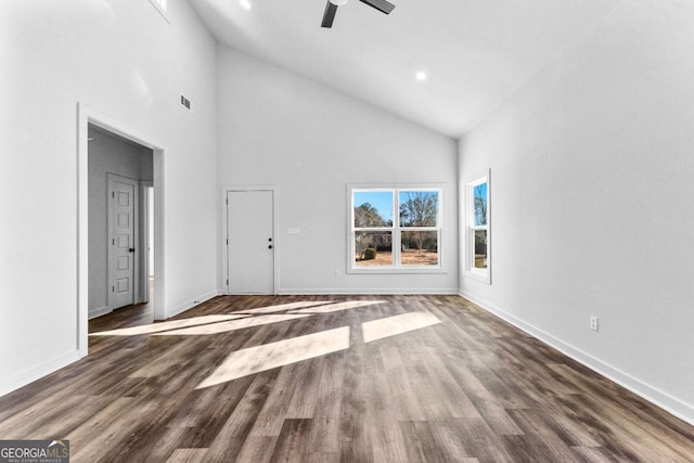 unfurnished living room with dark wood-type flooring, ceiling fan, and high vaulted ceiling