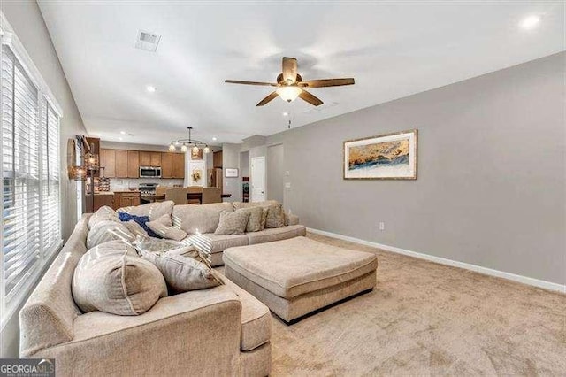 living room featuring ceiling fan and light carpet