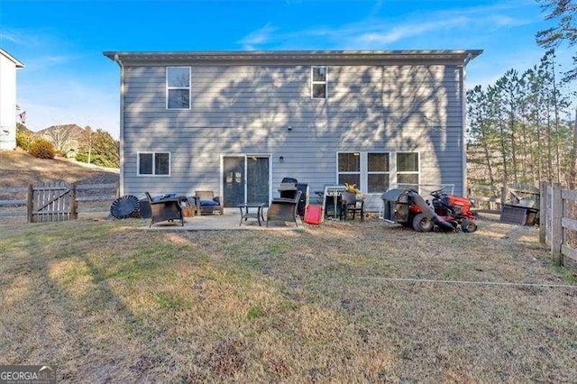 rear view of property featuring a patio area and a lawn