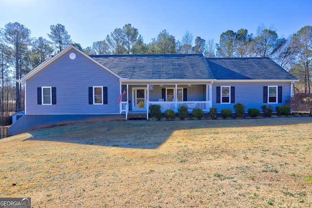 ranch-style house with covered porch and a front lawn