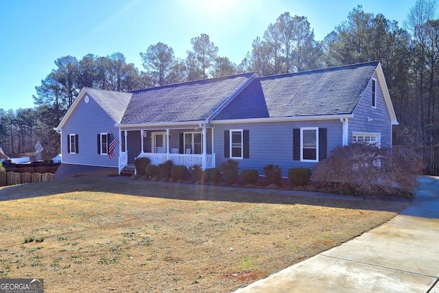 ranch-style home with a garage, a front yard, and covered porch