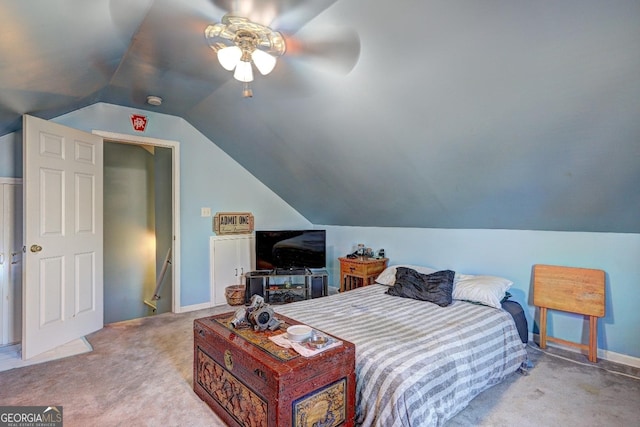 bedroom featuring vaulted ceiling, light carpet, and ceiling fan