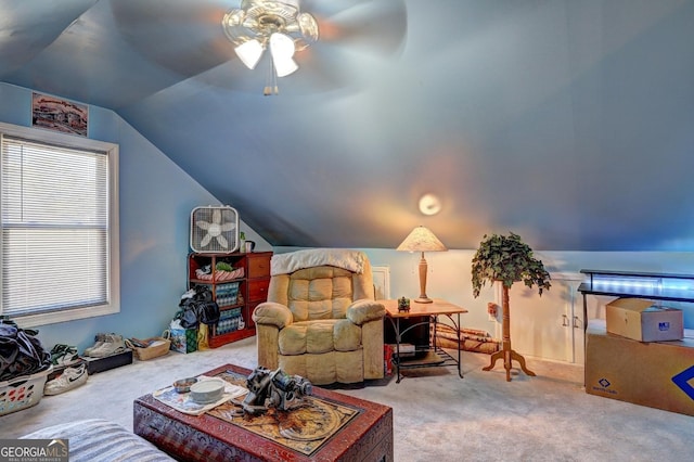 interior space with ceiling fan, carpet flooring, and vaulted ceiling