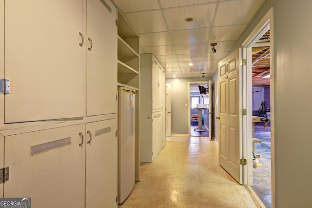 hallway featuring a paneled ceiling