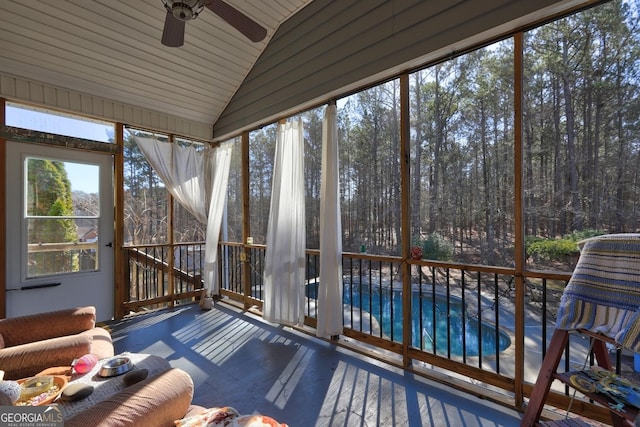 unfurnished sunroom with ceiling fan and lofted ceiling