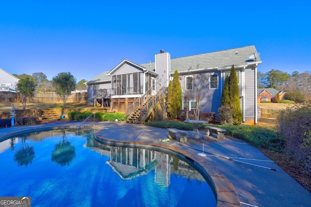 view of pool featuring a sunroom and a patio area