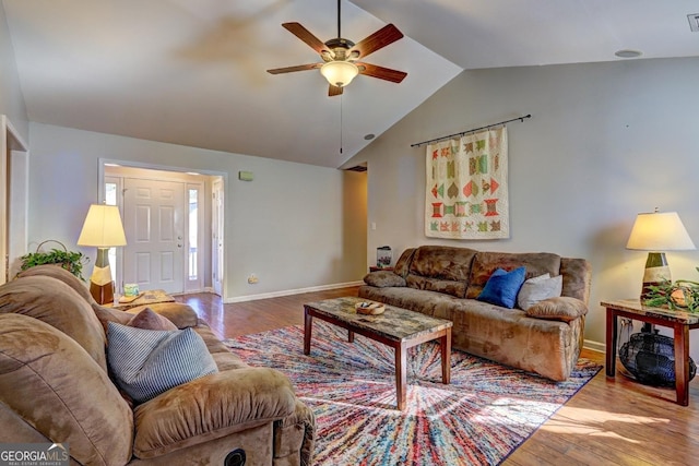 living room featuring lofted ceiling, light hardwood / wood-style floors, and ceiling fan