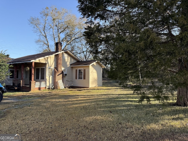 view of side of home featuring a lawn