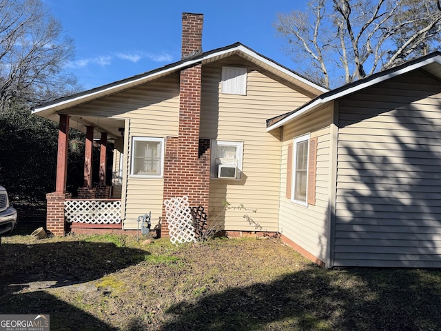 view of side of property with cooling unit and covered porch