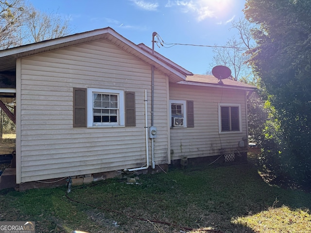 view of property exterior with a yard