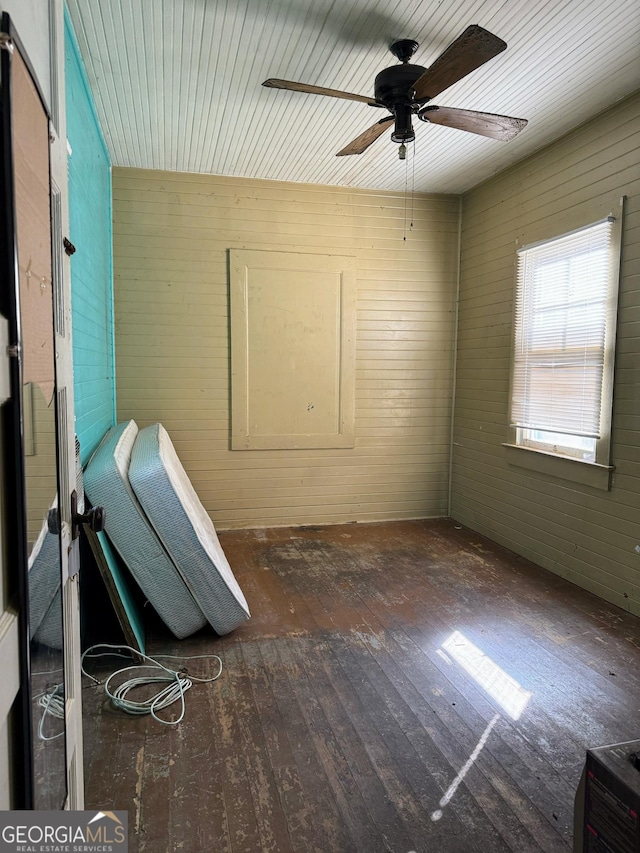 interior space with ceiling fan and dark hardwood / wood-style floors