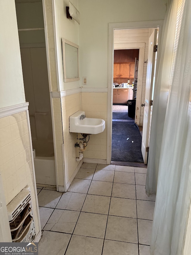 bathroom featuring tile walls, sink, and tile patterned flooring