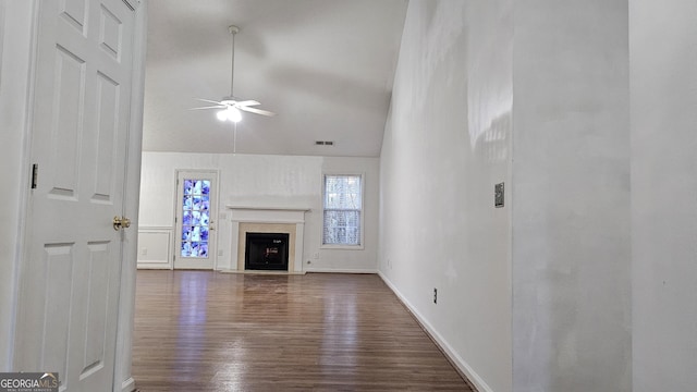 unfurnished living room with dark hardwood / wood-style flooring, vaulted ceiling, and ceiling fan