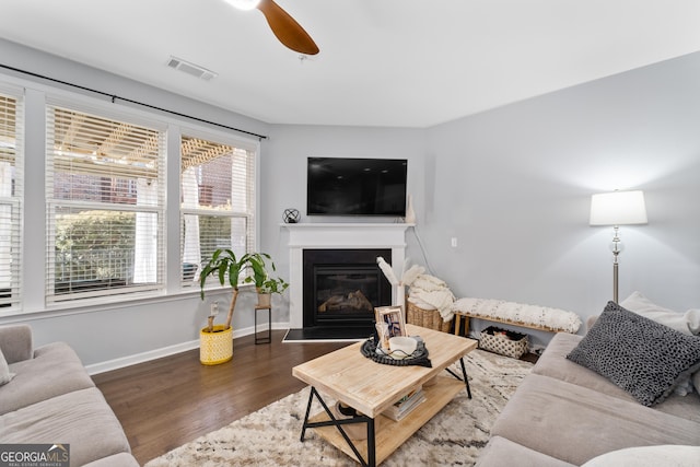 living room with hardwood / wood-style flooring and ceiling fan