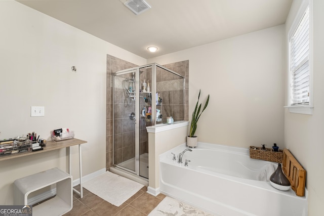 bathroom featuring tile patterned flooring and shower with separate bathtub