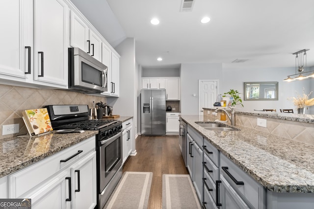 kitchen with white cabinetry, appliances with stainless steel finishes, and sink