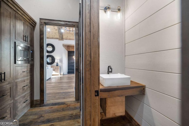 bathroom featuring sink and beam ceiling