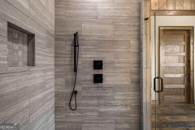 bathroom with a shower with shower door