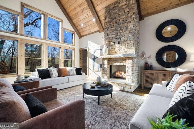 living room featuring wood ceiling, a stone fireplace, hardwood / wood-style floors, and beamed ceiling